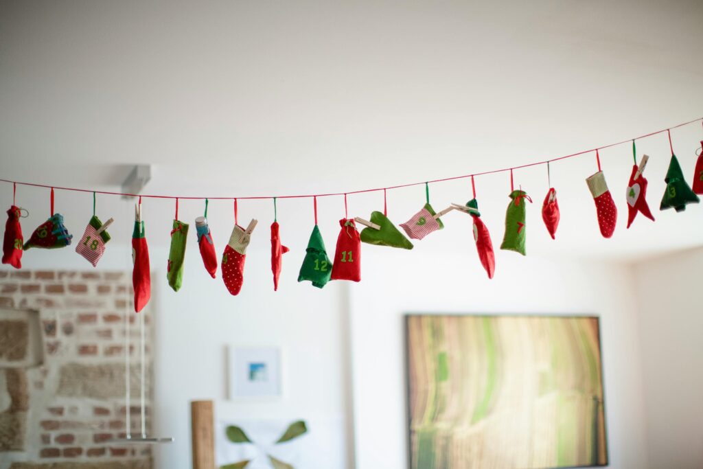 A festive fabric advent calendar with colorful sacks hanging indoors.